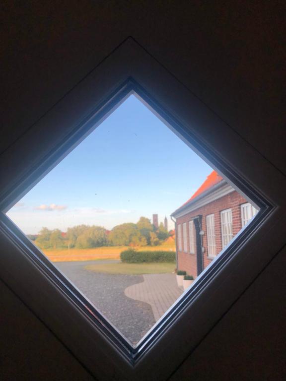 a view from aorthole window of a building at Bjerrumgaard in Ribe