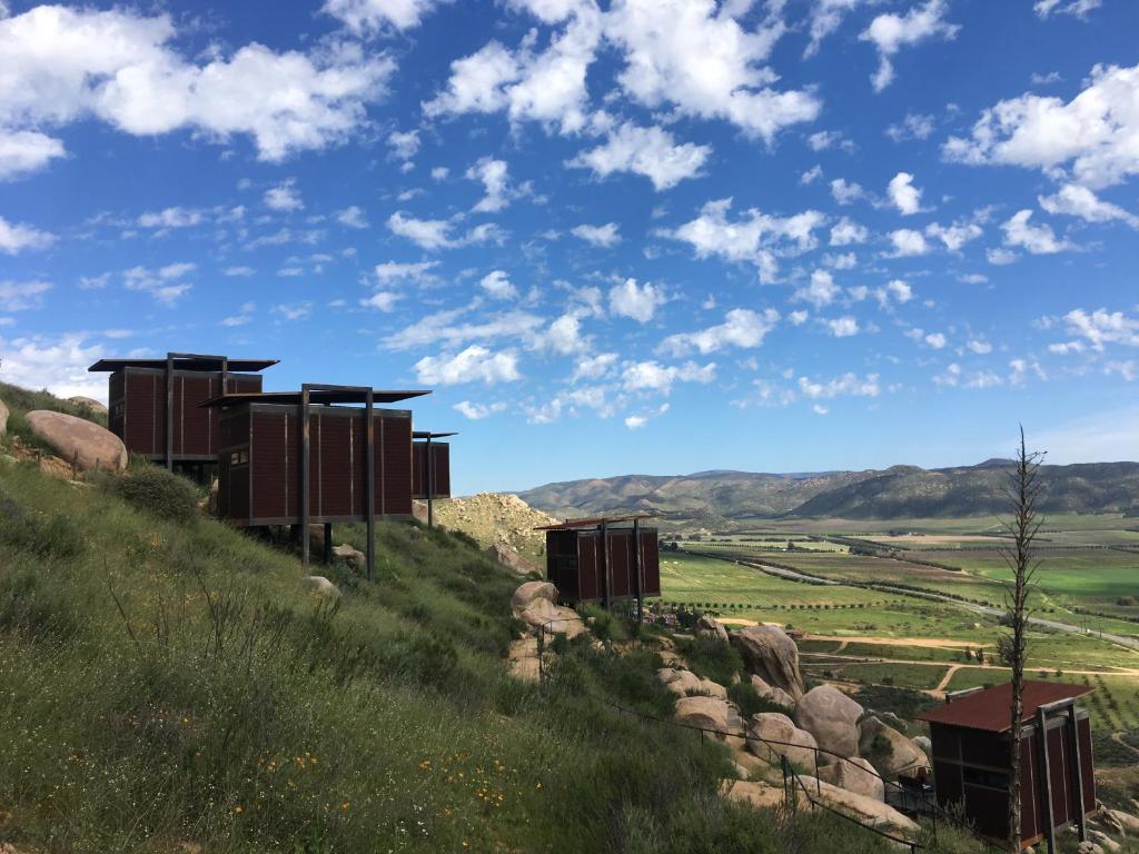 a train on a train track with mountains at Encuentro Guadalupe in Valle de Guadalupe