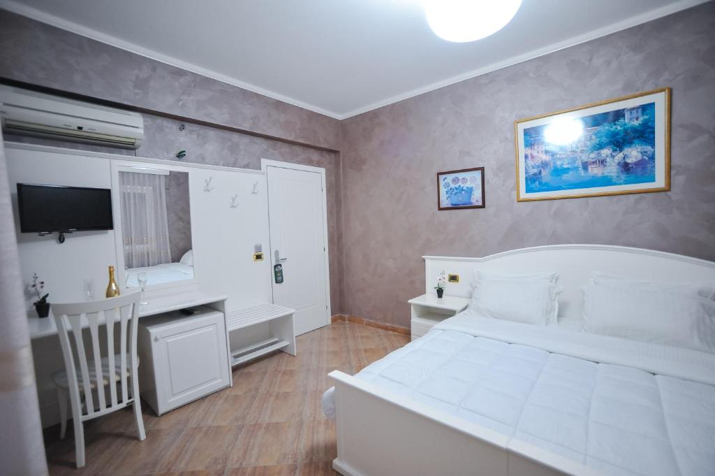 Postel nebo postele na pokoji v ubytování Iliria Internacional Hotel