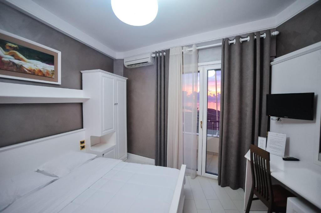 Postel nebo postele na pokoji v ubytování Iliria Internacional Hotel