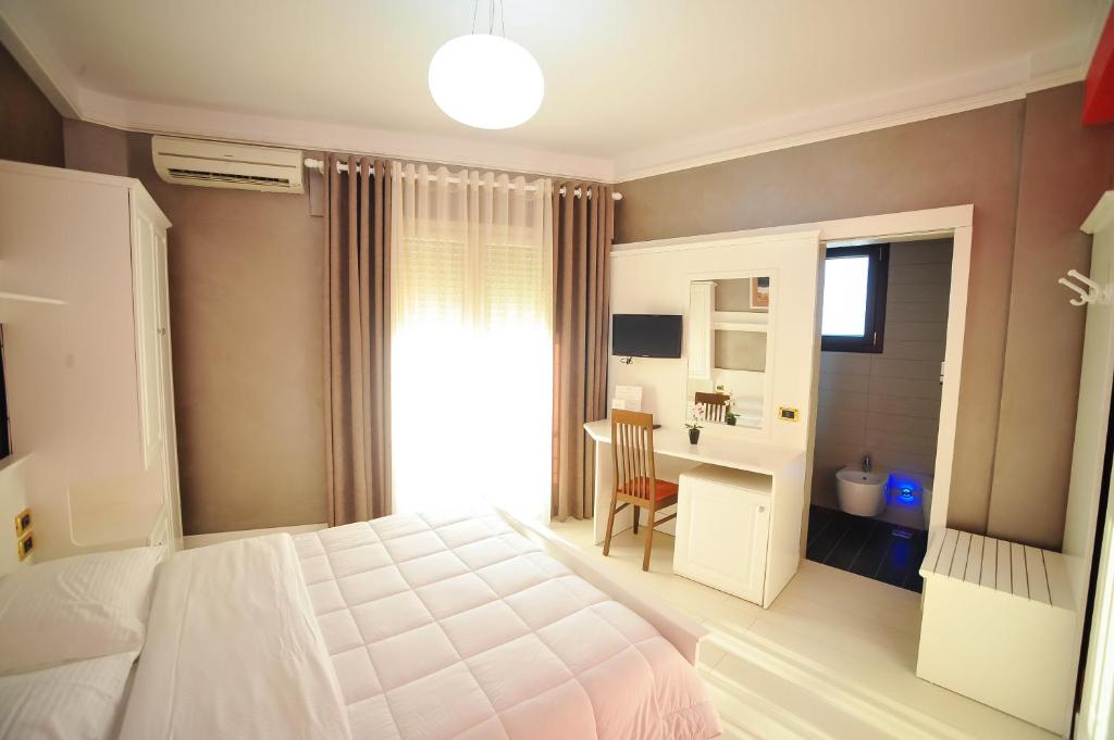Postel nebo postele na pokoji v ubytování Iliria Internacional Hotel