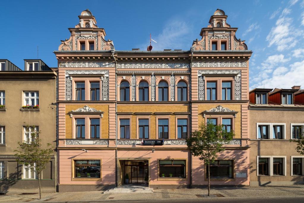 a large brick building with a lot of windows at Bohemia Inn Hotel in Turnov