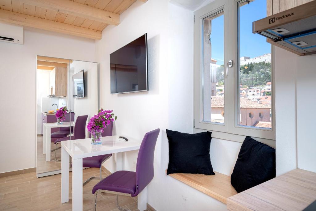 a small living room with a table and a window at Velada Center in Hvar