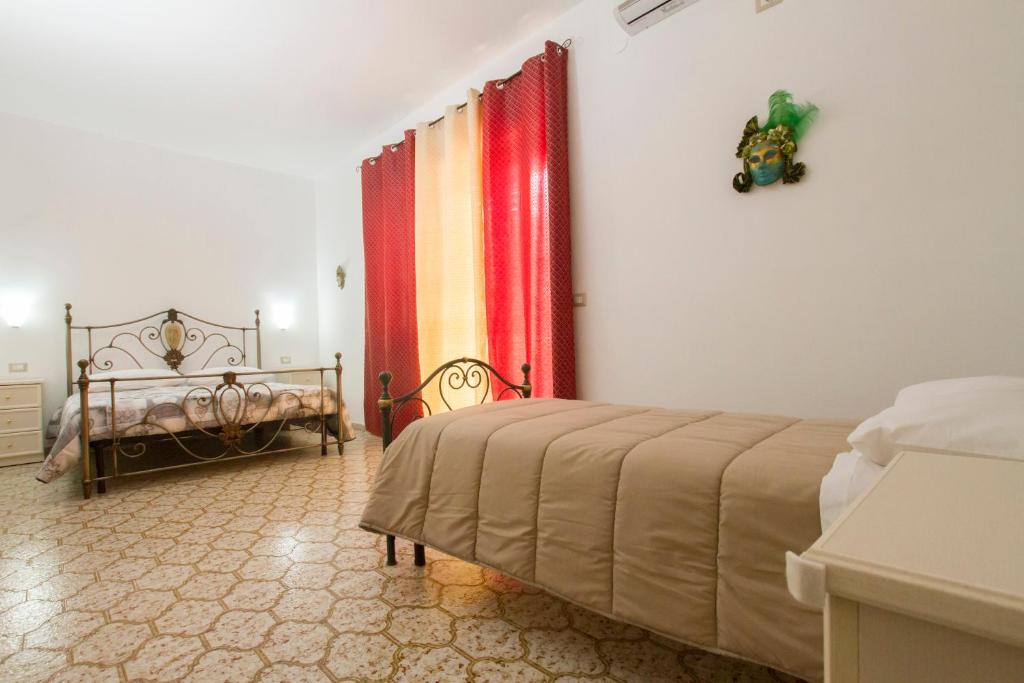 Postel nebo postele na pokoji v ubytování Le Maschere B&B