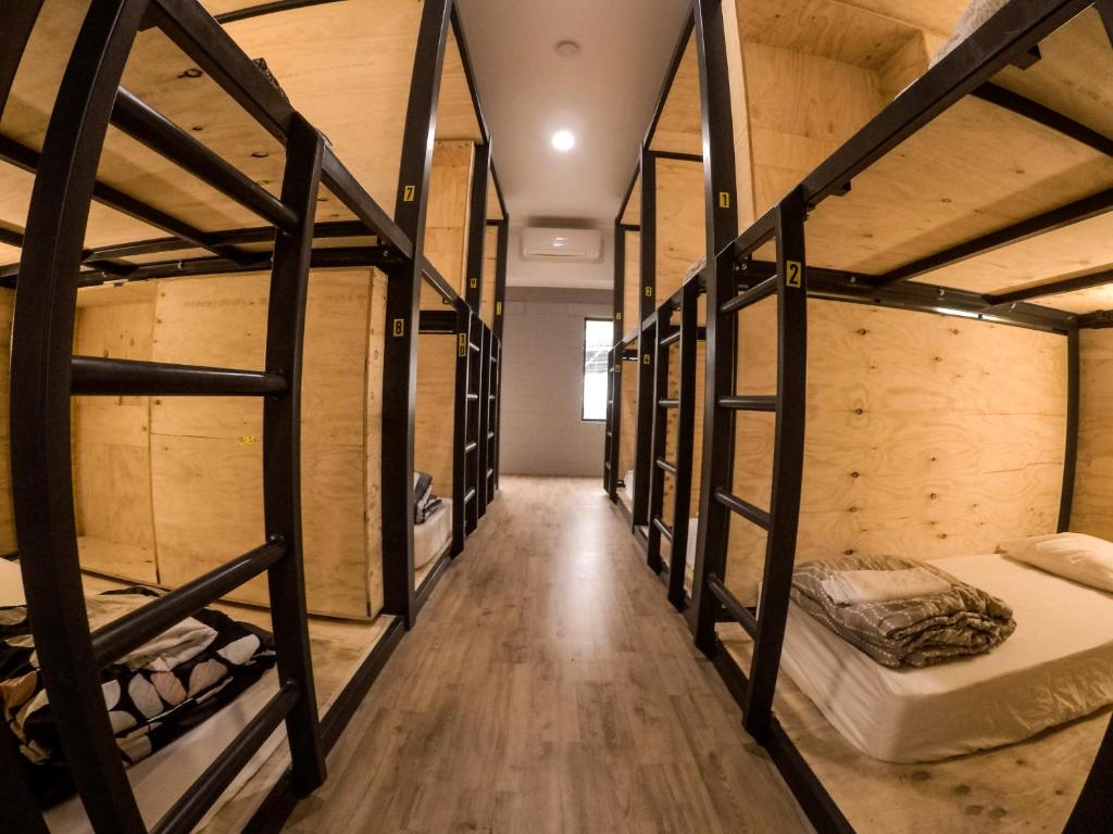 a group of bunk beds in a room at Bunk Inn Hostel in Bundaberg