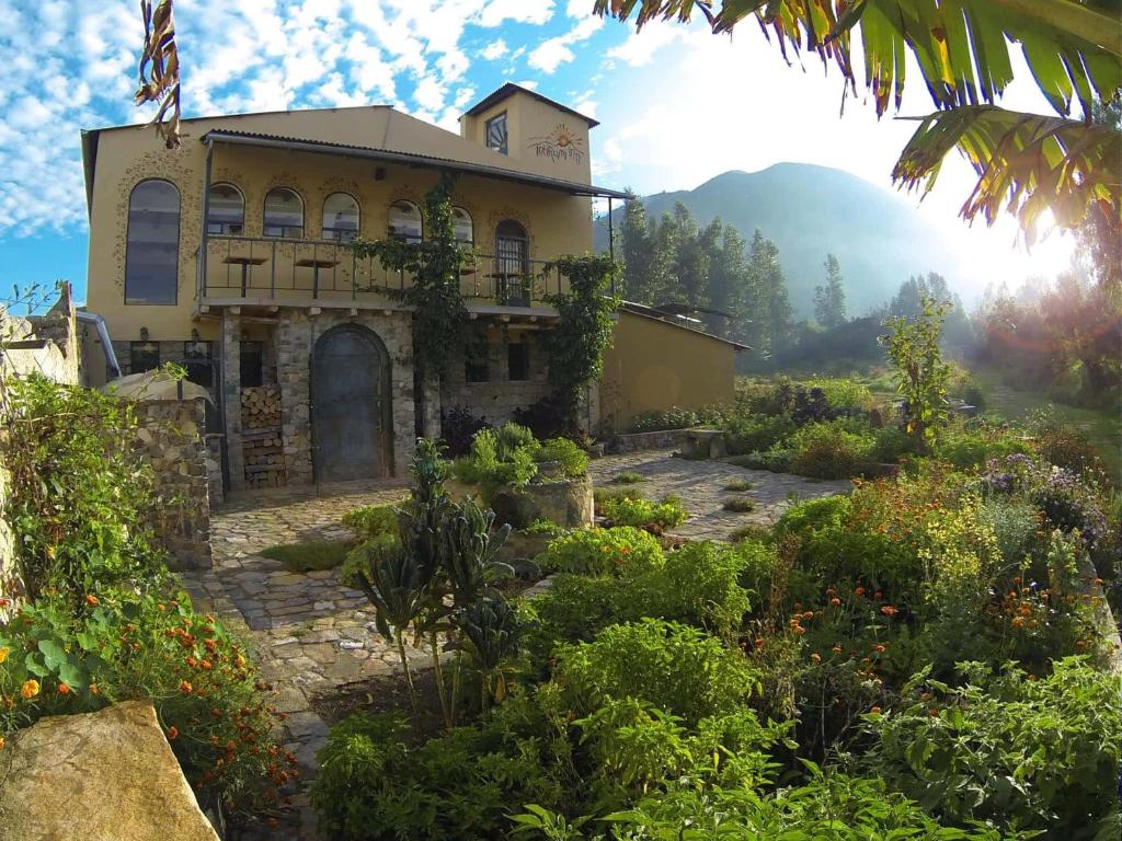 a house in the middle of a garden at IntiRumi Inn in Caraz