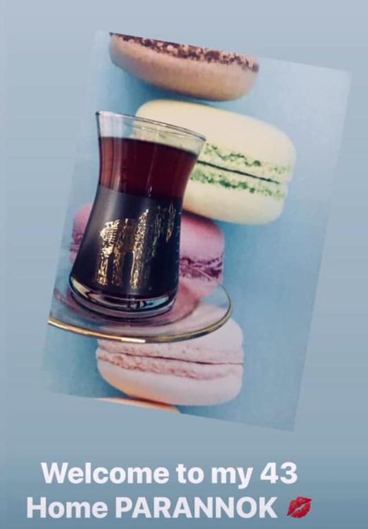 A styled coffee image with colorful macarons and a welcome message.