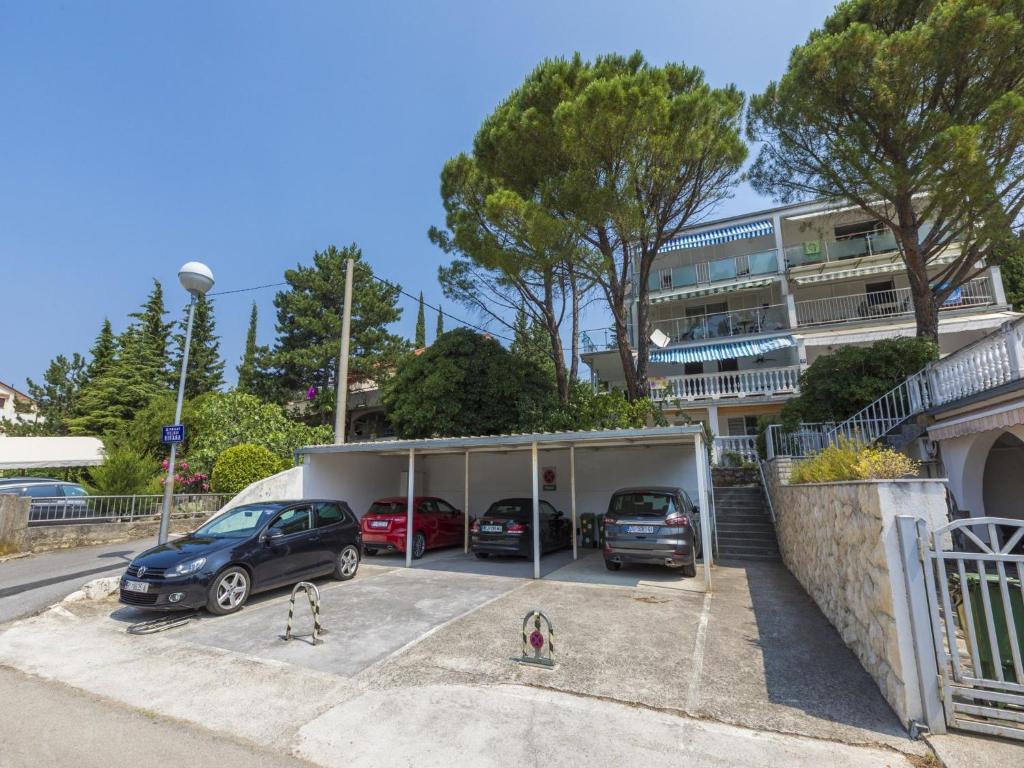 a car garage with cars parked in it at Apartment Cherry 2 in Selce