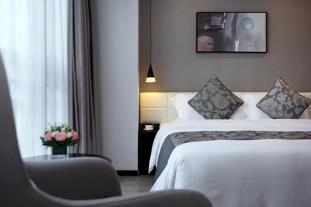 Postel nebo postele na pokoji v ubytování Hongdu Hotel