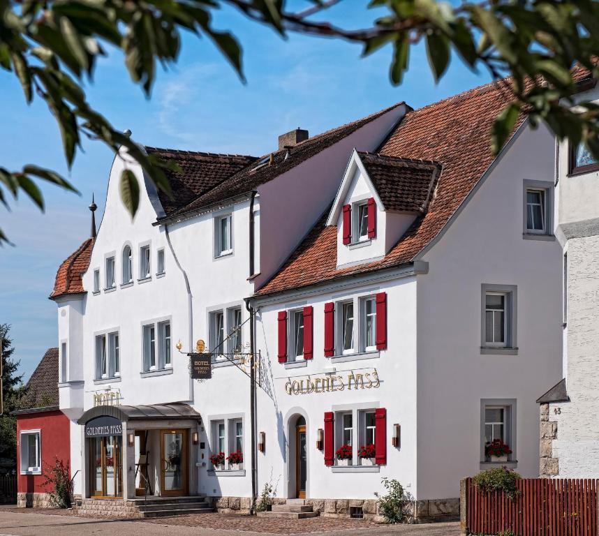 a large white building with red shutters at TOP Hotel Goldenes Fass in Rothenburg ob der Tauber