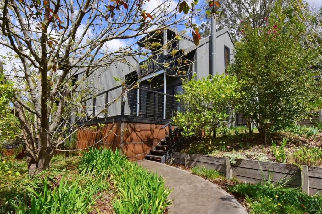 a house with a walkway in front of it at Cloudsong Chalet 2 Close to the village centre in Kangaroo Valley