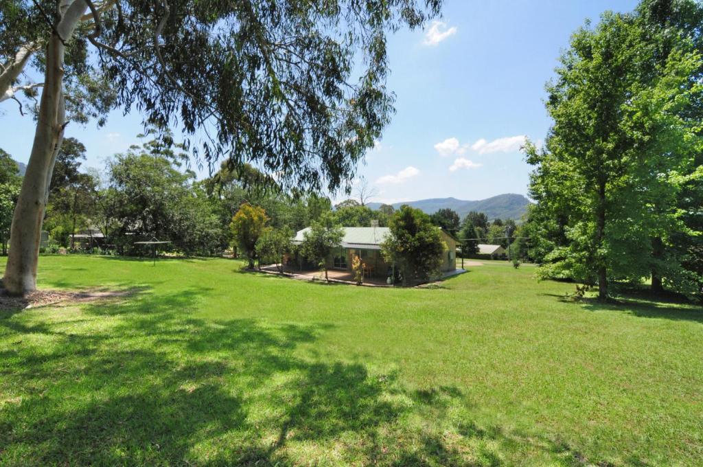un parque con árboles y una casa en la distancia en Valley Haven 3 bedrooms close to the village en Kangaroo Valley