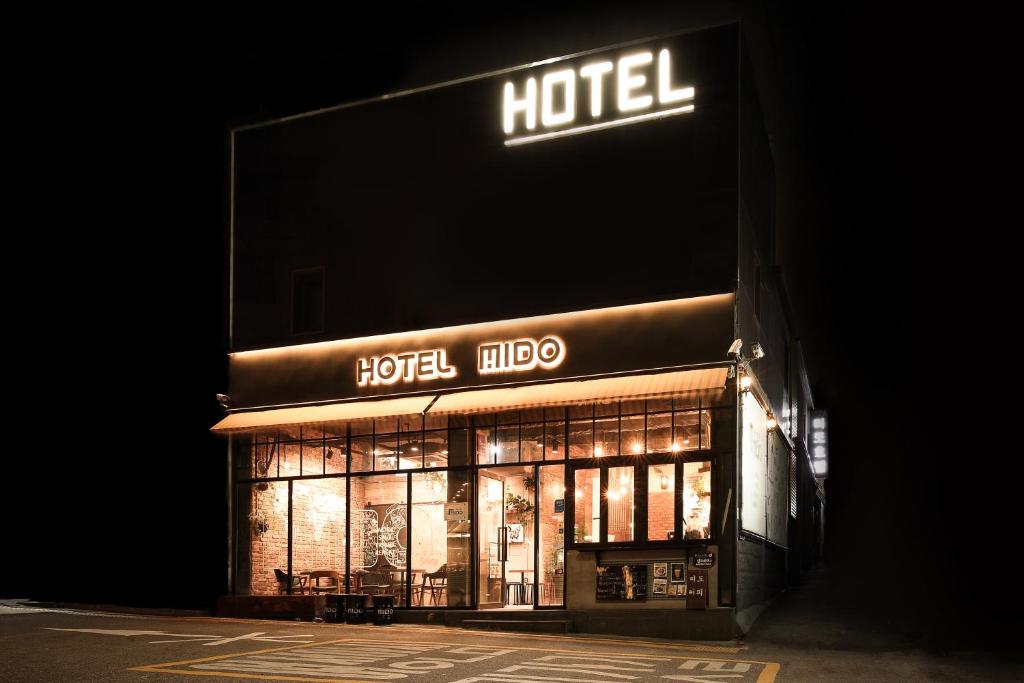 a hotel with a sign on the side of a building at Hotel MIDO Myeongdong in Seoul