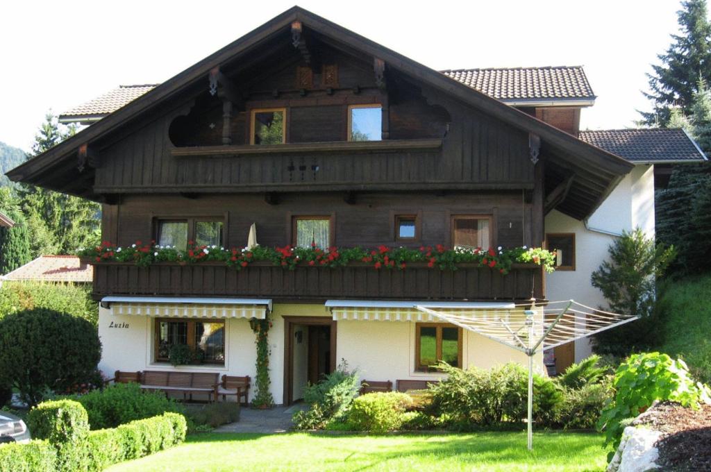 a house with flowers on the front of it at Haus Luzia in Reith im Alpbachtal