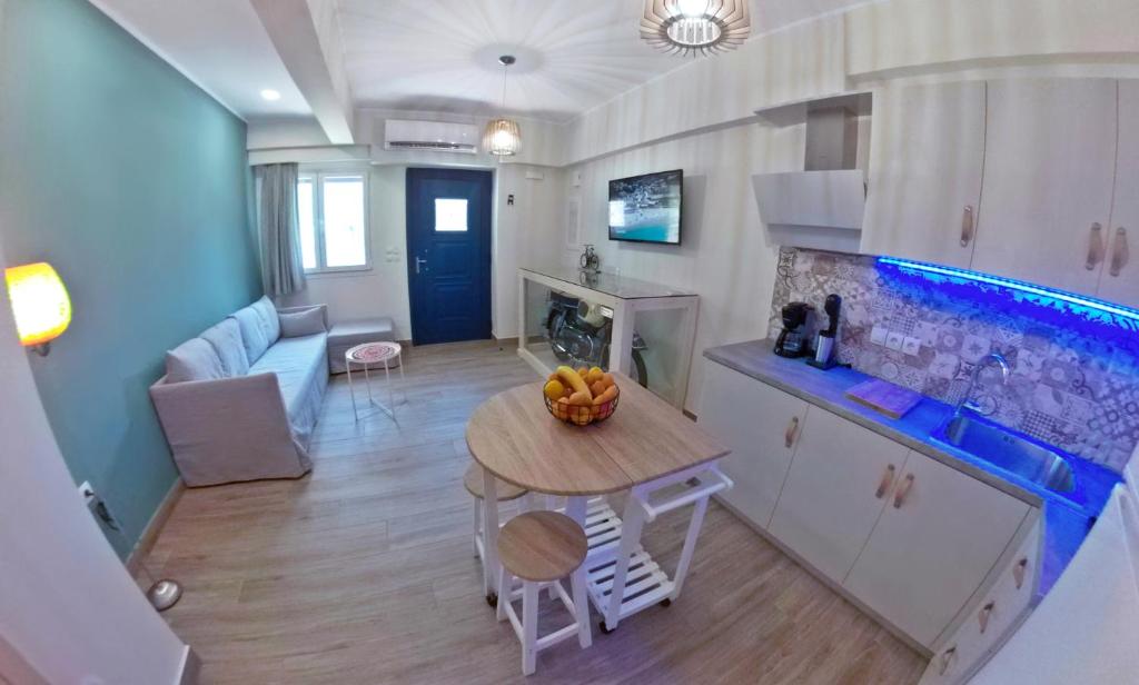 a kitchen and living room with a table with fruit on it at veraghi apartment 1 in Lefkada