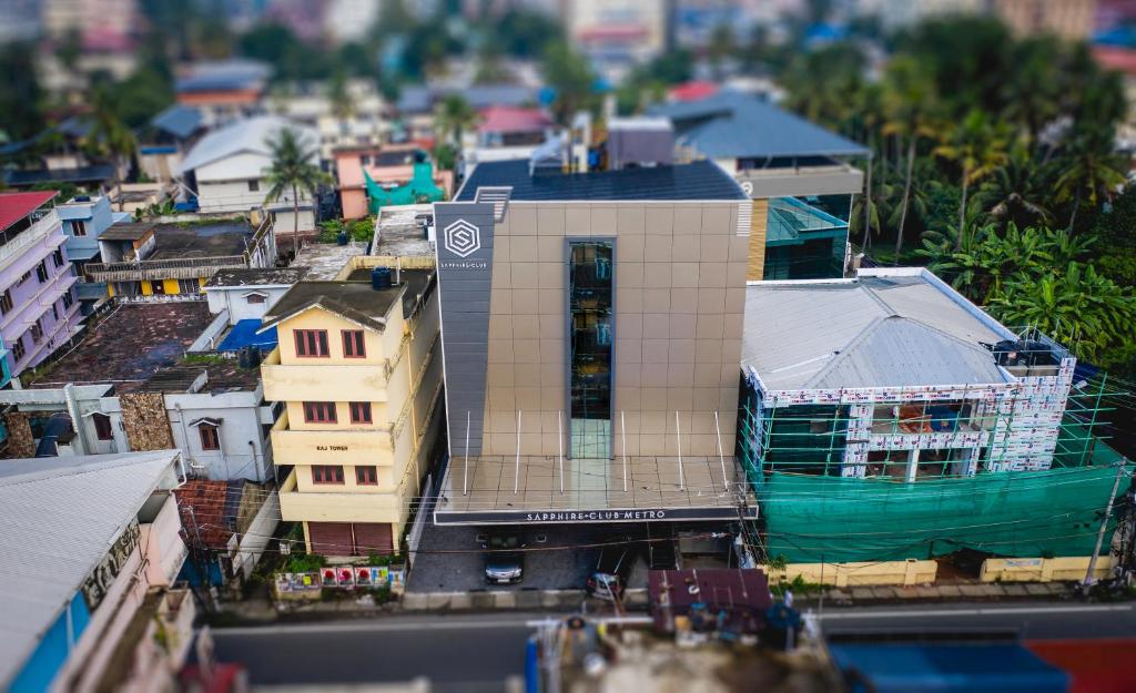 a view of a city with a tall building at Sapphire Club Metro in Ernakulam