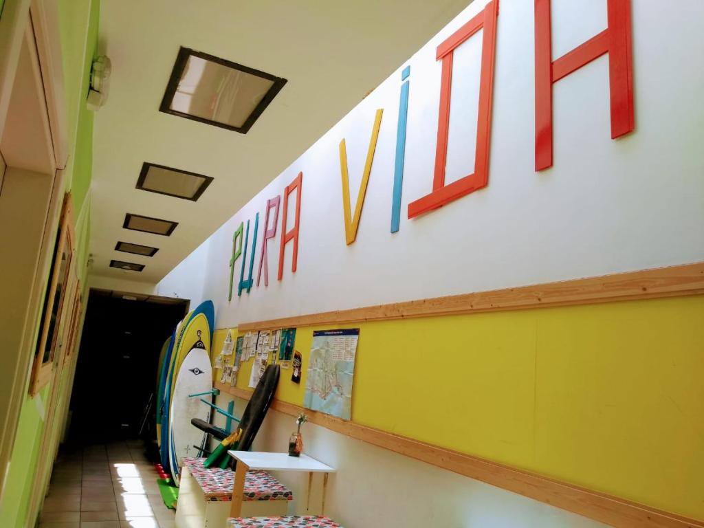 a hallway of a school with a sign on the wall at Pura Vida Las Palmas in Las Palmas de Gran Canaria