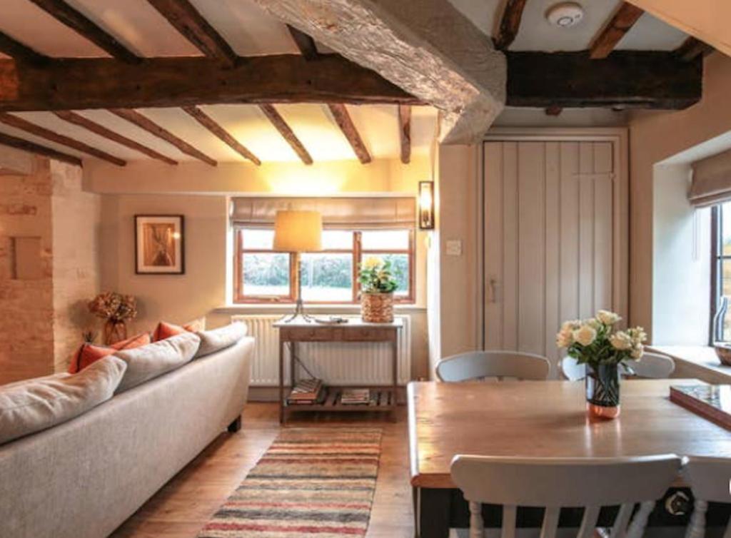 a living room with a couch and a table at The Stable, Yew Tree Farm Holidays, Tattenhall, Chester in Chester