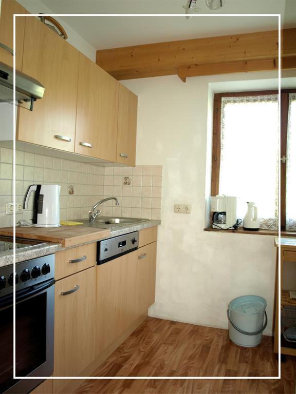 a kitchen with a sink and a stove top oven at Alpen Chalet ELLMAU Zentrum in Ellmau