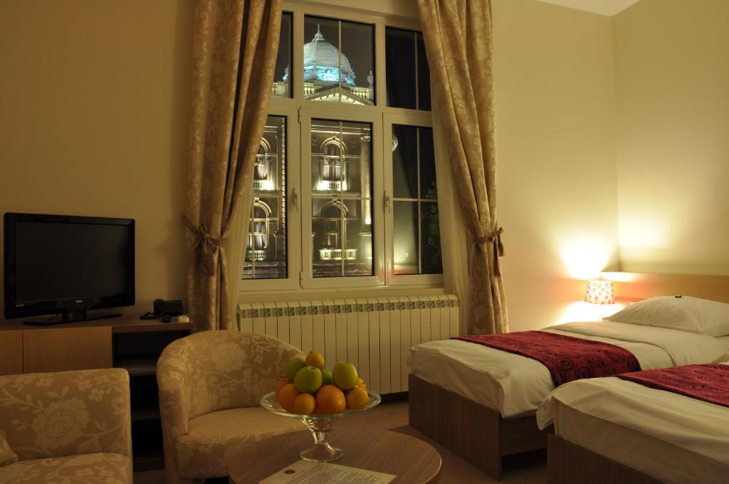 Postel nebo postele na pokoji v ubytování Apartments Legacy