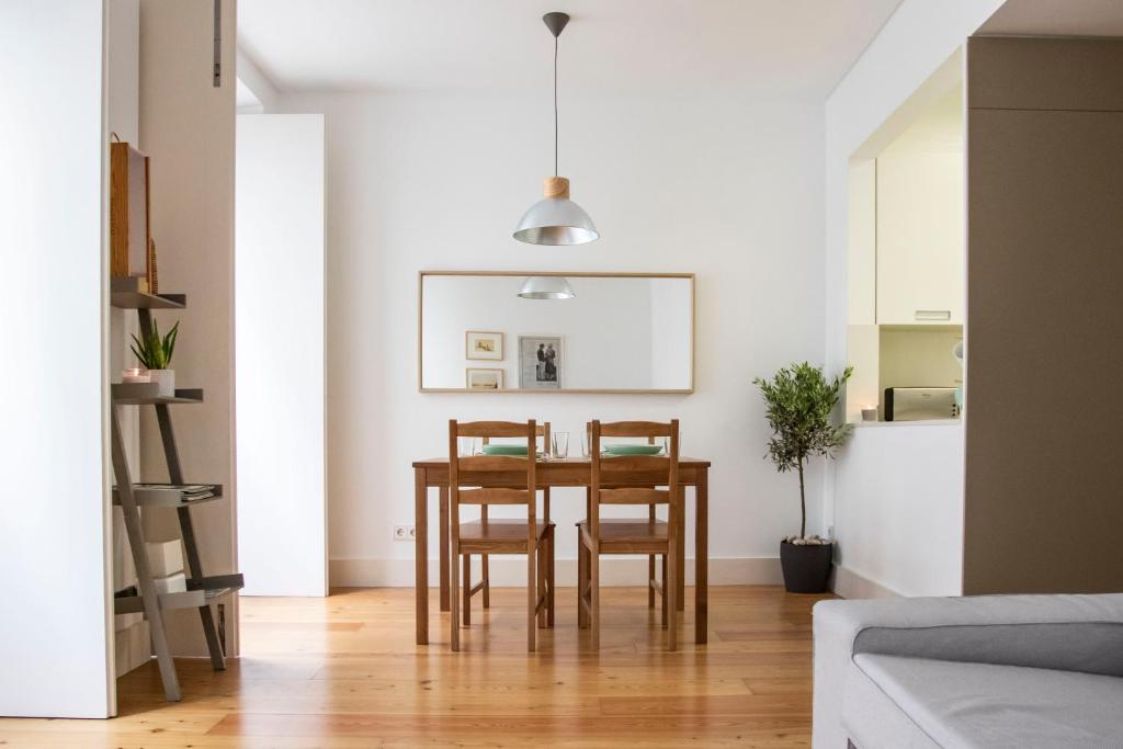 a dining room with a table and chairs at Principe Real Apartment in Lisbon