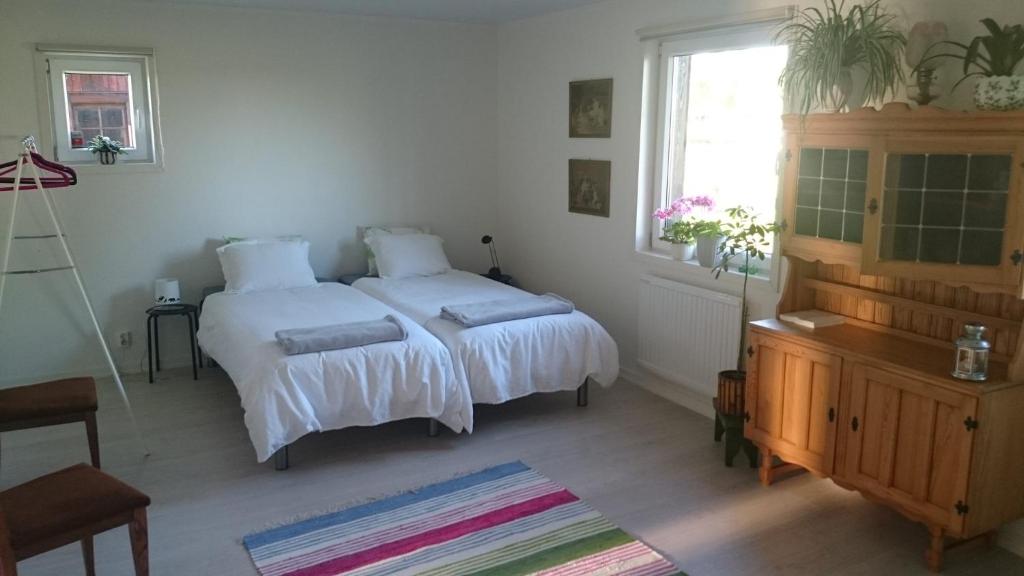 Åstorp的住宿－Humlarps Bed & Breakfast，一间卧室设有两张床和窗户。