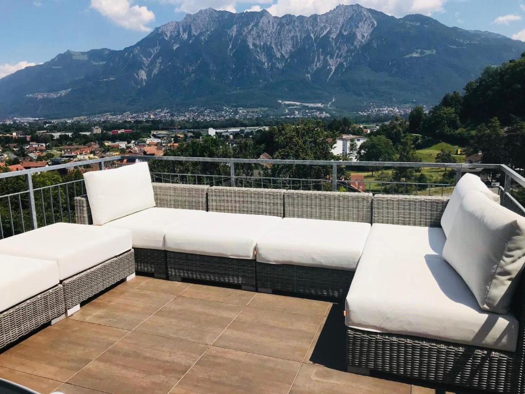 Elle comprend un balcon doté d'un mobilier blanc et offrant une vue sur la montagne. dans l'établissement Alpen Panorama view Luxury House with green Garden, à Buchs