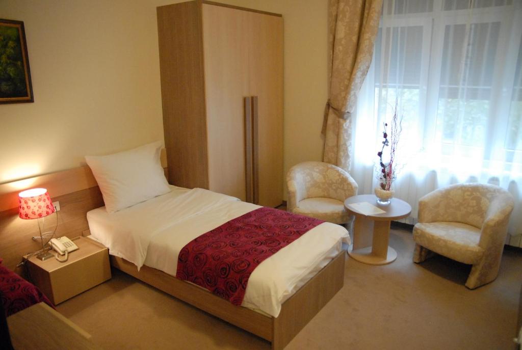 Postel nebo postele na pokoji v ubytování Apartments Legacy