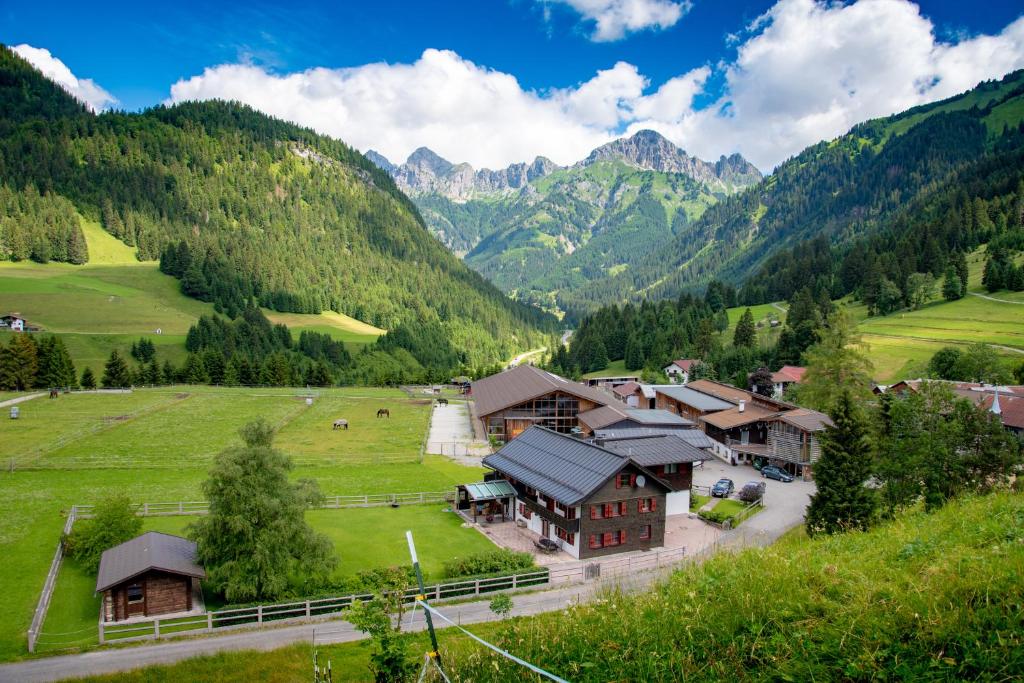 an aerial view of a farm with mountains in the background at Reiterhof Berggut Gaicht in Nesselwängle