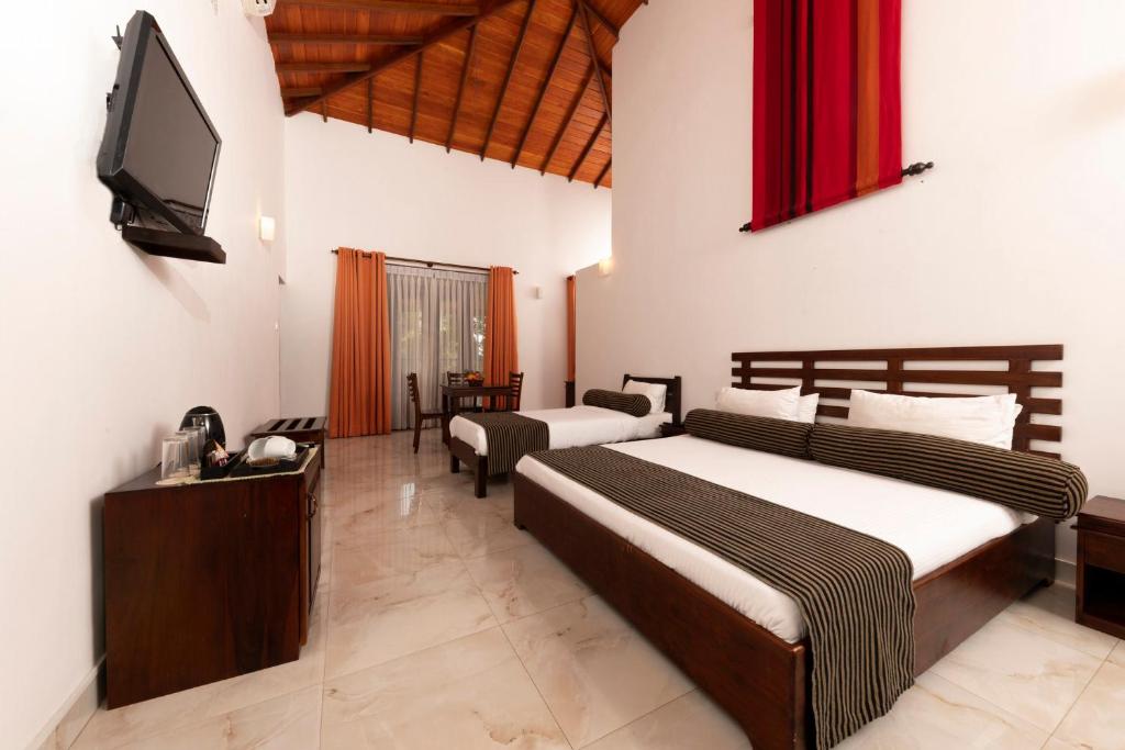 Postel nebo postele na pokoji v ubytování Melheim Kandy Villas