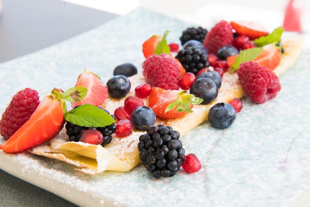 a plate of fruit on top of a plate at Dimora Talenti in Polignano a Mare