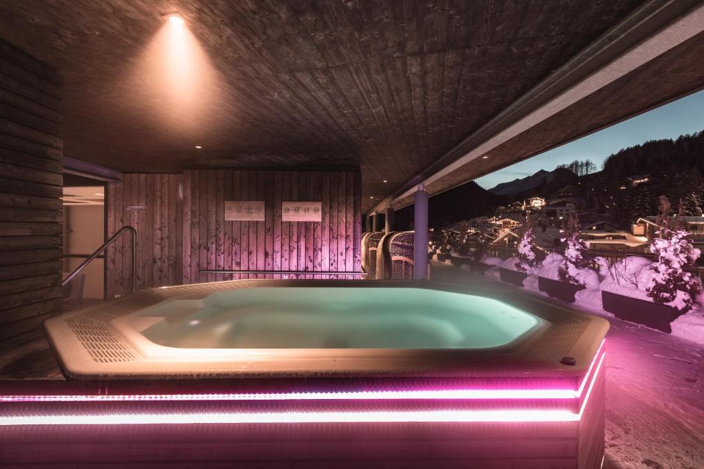 a jacuzzi tub in a house with a view at Anthony's Life&Style Hotel in Sankt Anton am Arlberg