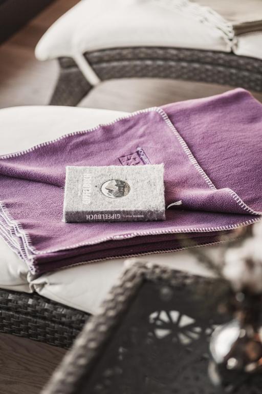 a pile of purple napkins sitting on top of a table at Anthony's Life&Style Hotel in Sankt Anton am Arlberg