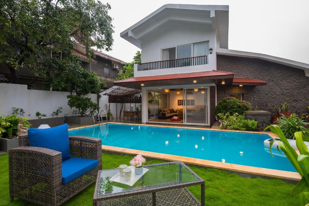a pool in the backyard of a villa at EL Lodge by StayVista - Pool, lawn, and a charming gazebo for your perfect getaway in Lonavala