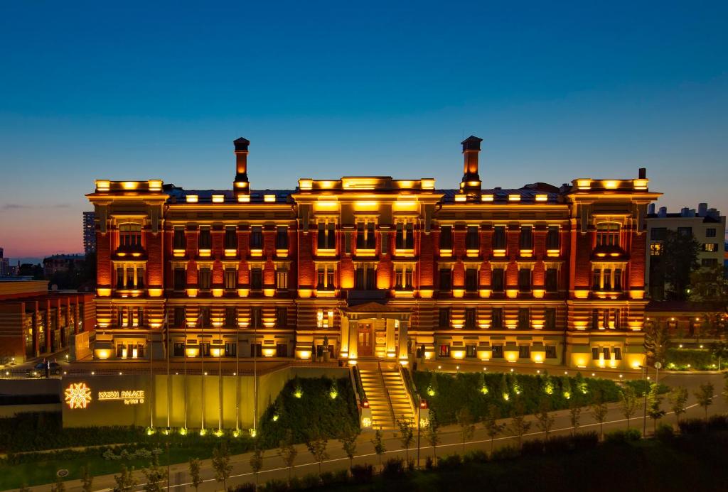 a large building with lights on it at night at Kazan Palace by Tasigo in Kazan