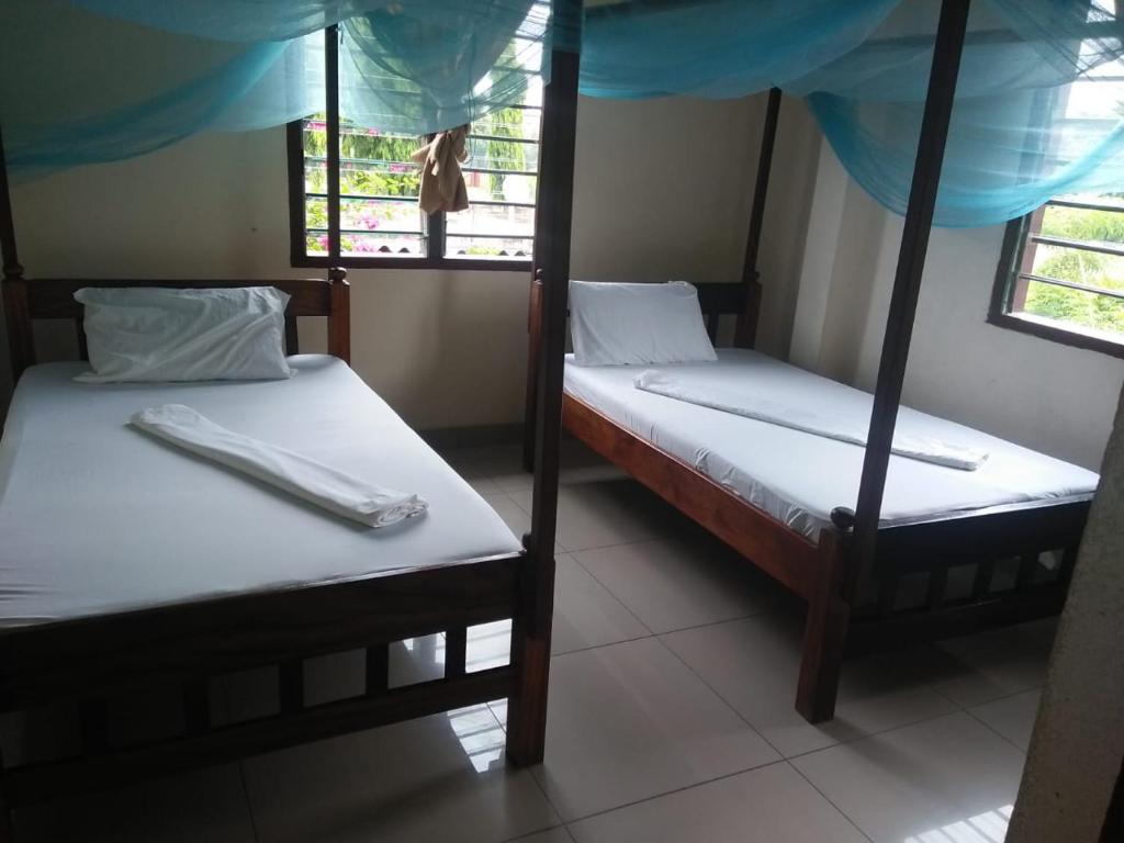 מיטה או מיטות בחדר ב-Cingaki Hotel