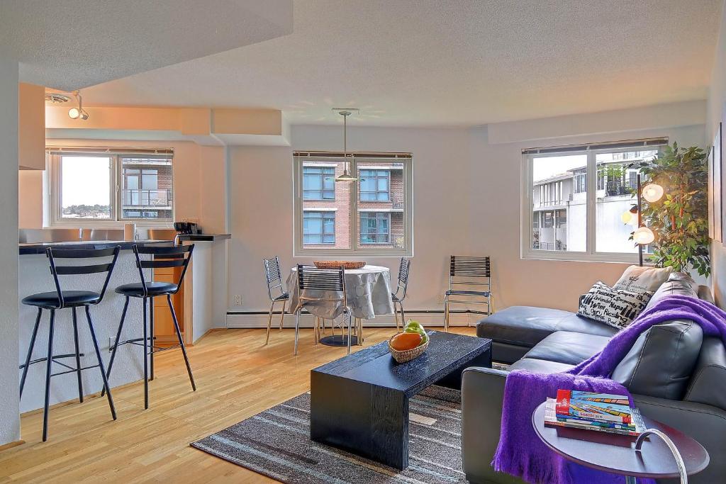 a living room with a couch and a table at Hubble Place Condos in Seattle