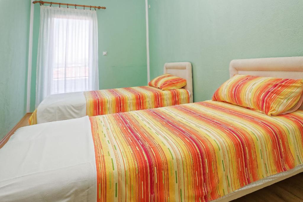 Postel nebo postele na pokoji v ubytování Apartments Ajla