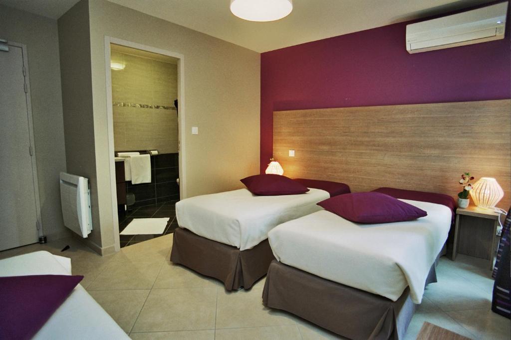 Postel nebo postele na pokoji v ubytování Hôtel l'Anvia