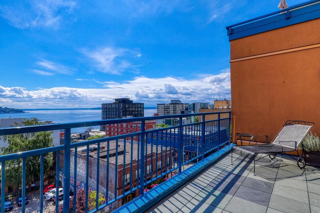 a balcony with a chair and a view of the water at Belltown Court North in Seattle
