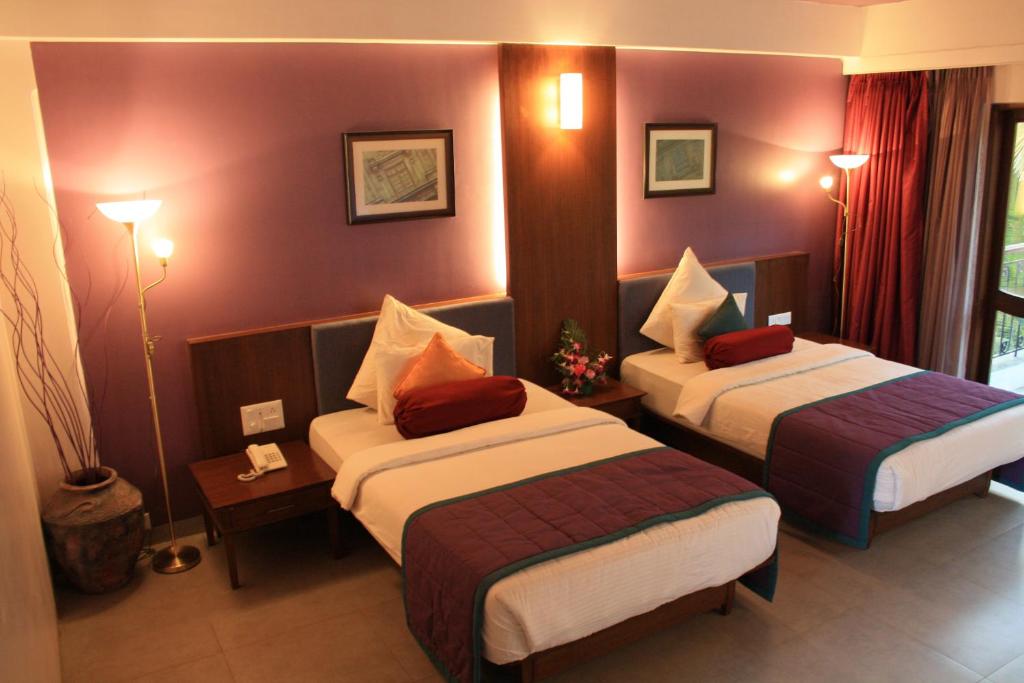 Postel nebo postele na pokoji v ubytování Tangerine Boutique Resort