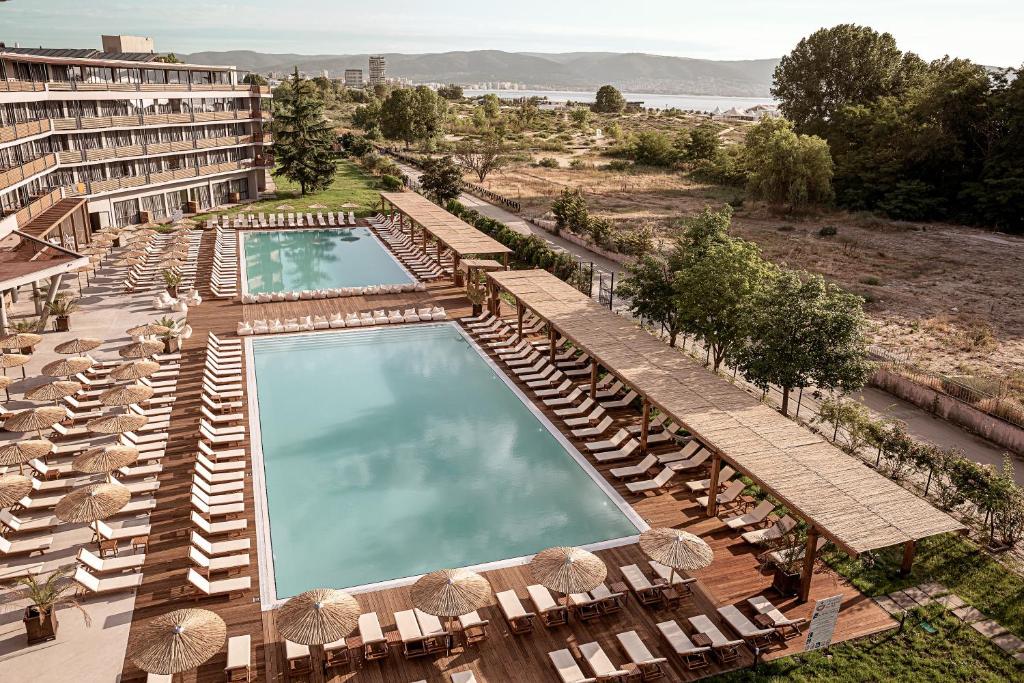 an aerial view of a hotel with chairs and a swimming pool at Sunny Beach Club - Adults Only #YouthfulVibes in Sunny Beach