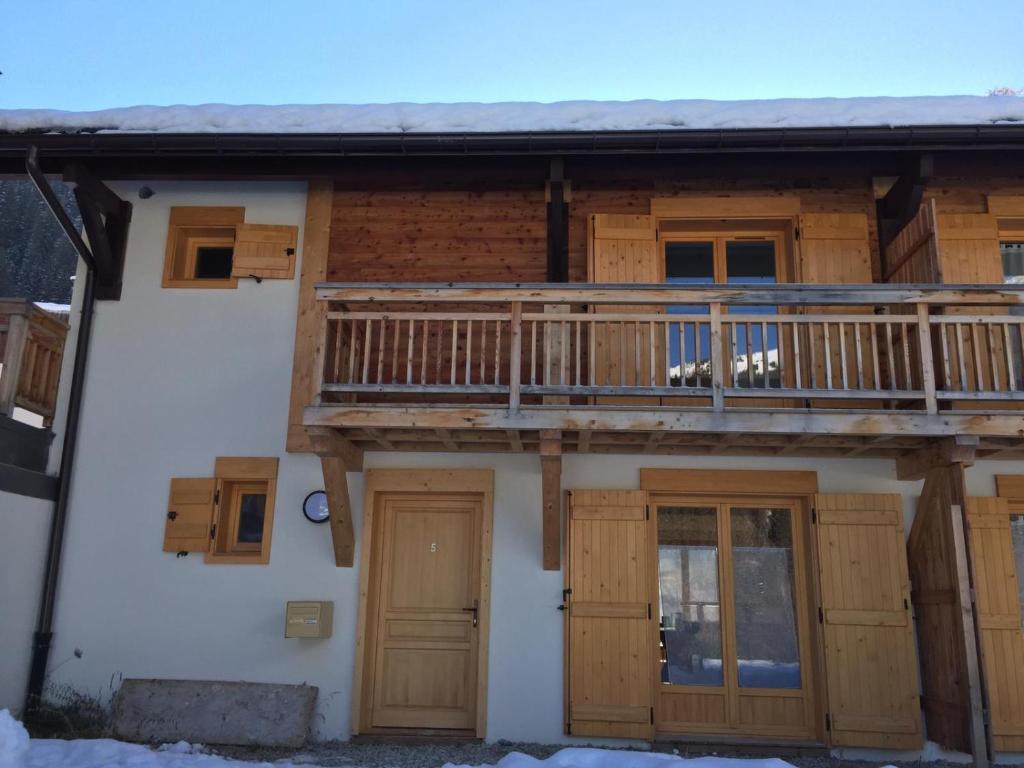 a house with a balcony and a deck at Chalet Les Contamines in Les Contamines-Montjoie