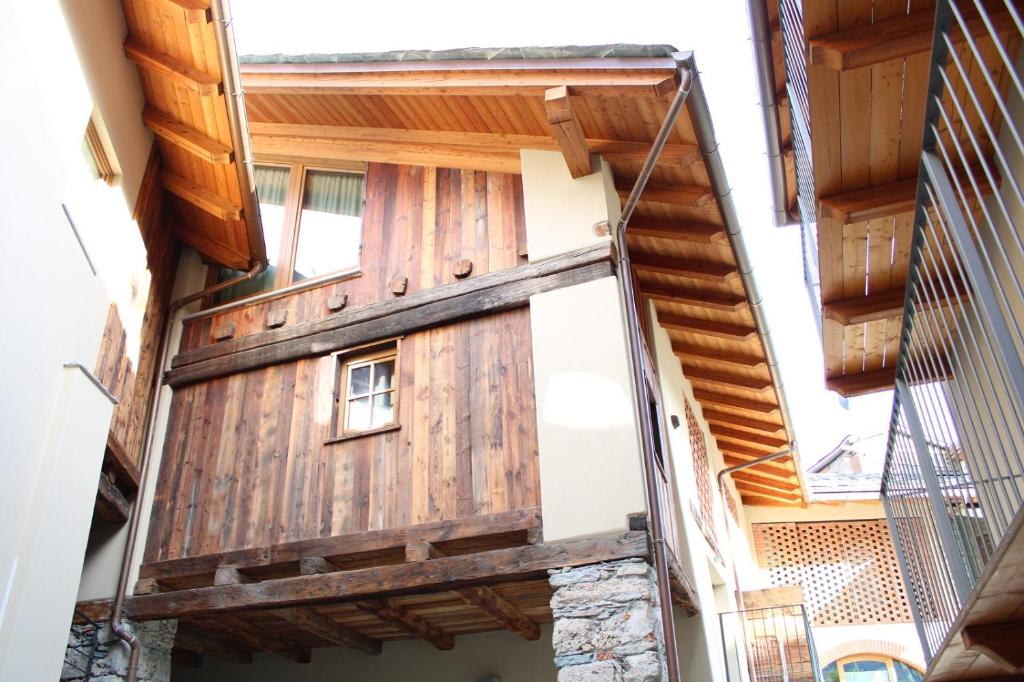 a building with a wooden door on the side of it at L'Atelier du Temps - Les Greniers Appartements in Aosta