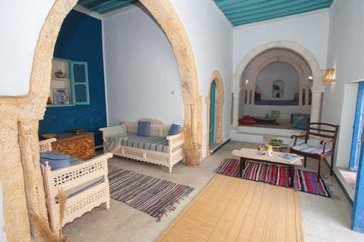 a living room with a couch and a table at Dar Tenast in Houmt Souk