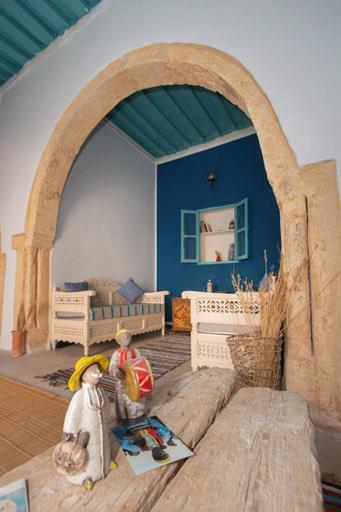 two figurines of people sitting in a room at Dar Tenast in Houmt Souk