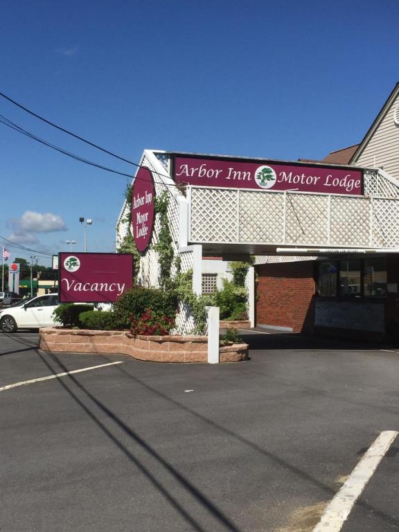 a store with a sign in front of a parking lot at Arbor Inn - Weymouth in Weymouth