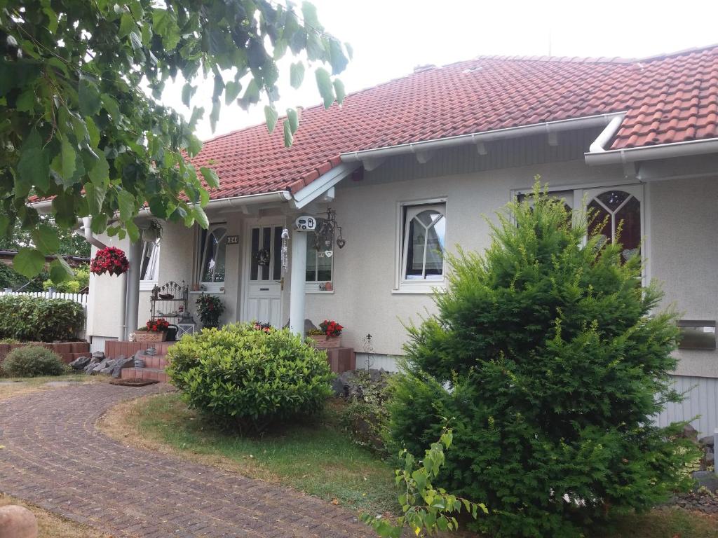 a white house with a christmas tree in front of it at Ferienwohnung Reuter in Niederzissen