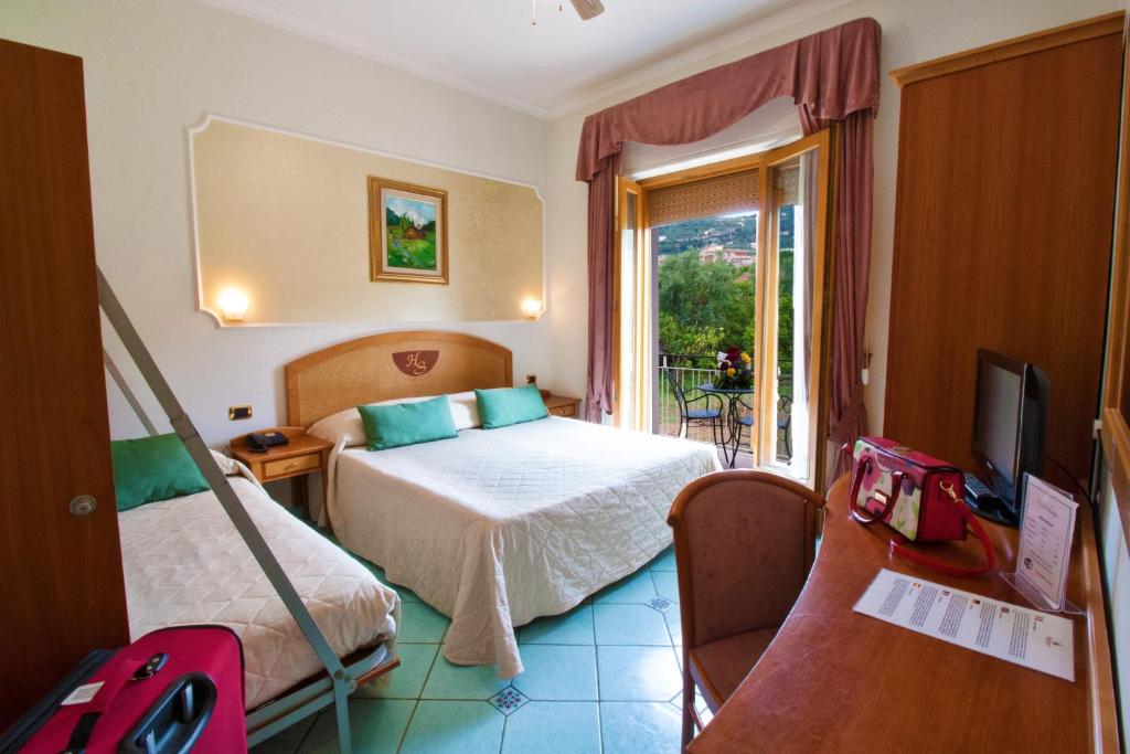 a hotel room with a bed and a television at Hotel Savoia Sorrento in Sorrento