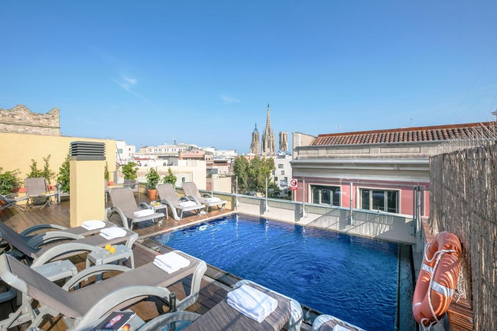 a large building with a large pool of water in front of it at Catedral Bas Apartments by Aspasios in Barcelona